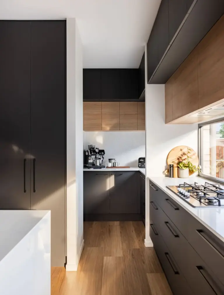 Galley kitchen with black and timber cabinetry, gas cooktop and walk-in pantry